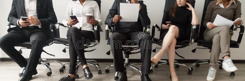 Horizontal image diverse applicants sitting in queue waiting job interview stock photos Horizontal image diverse applicants sitting in queue waiting job interview stock photos