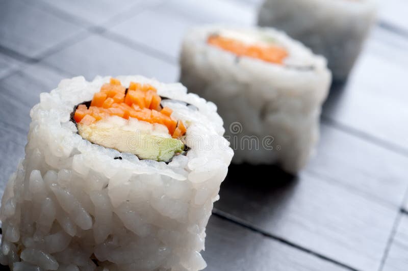 Horizontal macro of 3 rolls of sushi