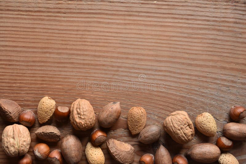 Mixed nuts with copy space on wood stock photos Mixed nuts with copy space on wood stock photos