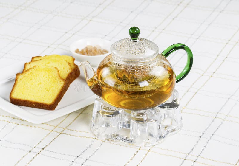 Fresh Green Tea in Glass Pot with snack food