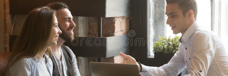 Insurance broker telling to young married couple about mortgage offer royalty free stock photos