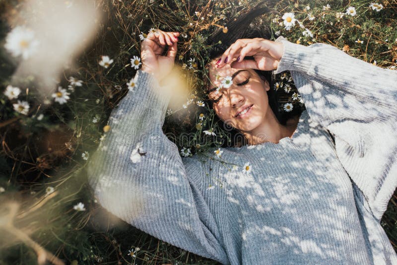 Horizontal portrait of an attractive Caucasian woman smile and feel free and dream on meadow with copy space. Beautiful brunette stock photo Horizontal portrait of an attractive Caucasian woman smile and feel free and dream on meadow with copy space. Beautiful brunette stock photo