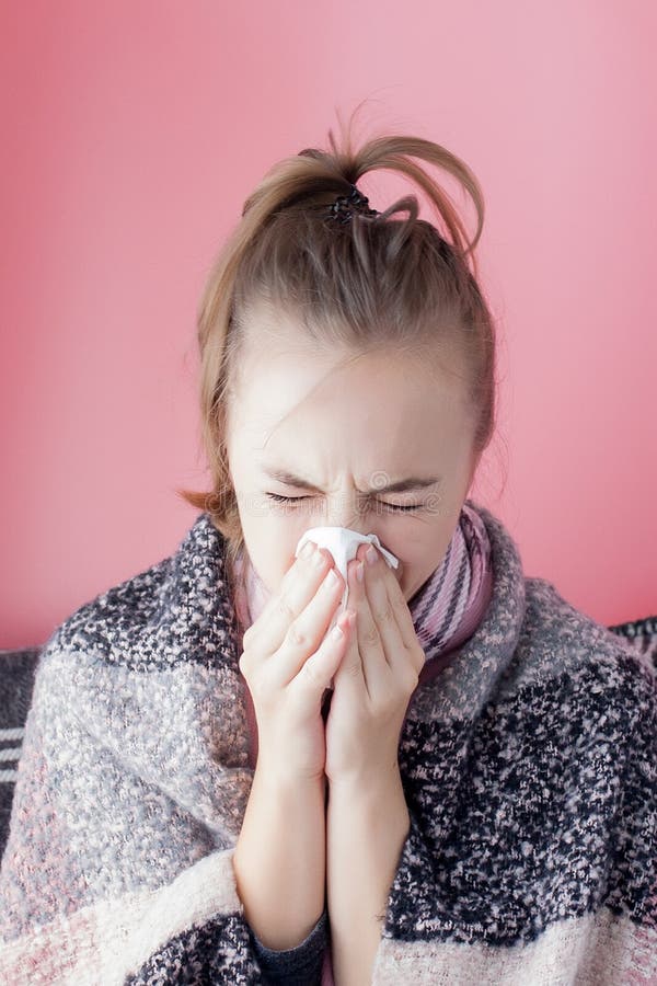 Horizontal portrait young girl with a handkerchief and runny nose in profile, sneezing from flu, white skinned female model at stock photos Horizontal portrait young girl with a handkerchief and runny nose in profile, sneezing from flu, white skinned female model at stock photos