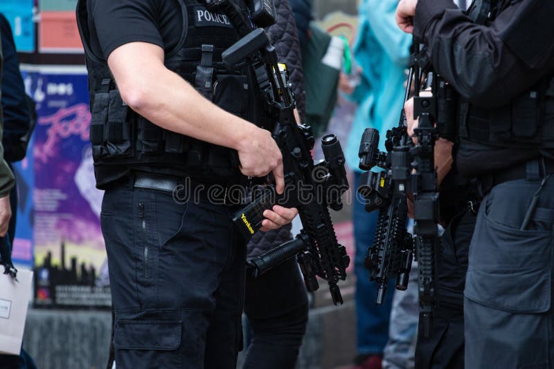 Horizontal shot of armed police patrolling tour de yorkshire