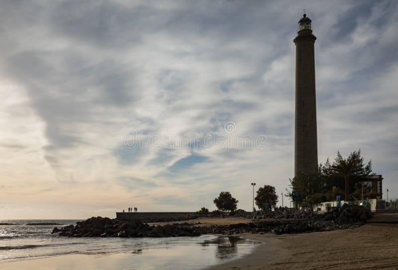 The beautiful beach in Maspalomas, with Faro de Maspalomas or Maspalomas lighthouse, in the background, Gran Canaria royalty free stock photo The beautiful beach in Maspalomas, with Faro de Maspalomas or Maspalomas lighthouse, in the background, Gran Canaria royalty free stock photo