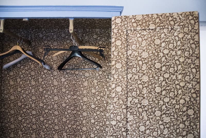 Horizontal shot of black and brown cloth hangers in a wardrobe with a floral design. A horizontal shot of black and brown cloth hangers in a wardrobe with a royalty free stock image Horizontal shot of black and brown cloth hangers in a wardrobe with a floral design. A horizontal shot of black and brown cloth hangers in a wardrobe with a royalty free stock image
