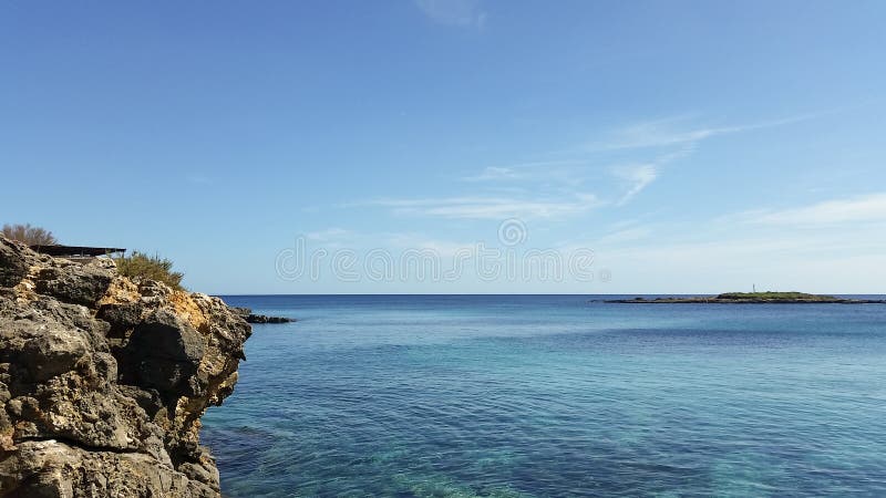 Horizontal Shot of Crystal Clear Ocean and Cliff at Ognina Island ...