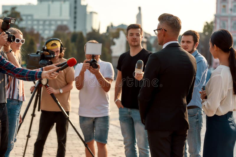 Before you make up your mind. Journalists conducting interview of politician. Journalism industry, live streaming. Horizontal shot of politician giving interview stock photography Before you make up your mind. Journalists conducting interview of politician. Journalism industry, live streaming. Horizontal shot of politician giving interview stock photography