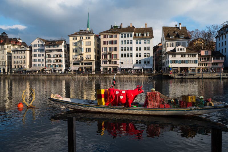 Horizontal View of Zurich S Limmat River with a Floating Boat, a Red Cow Inside and Old