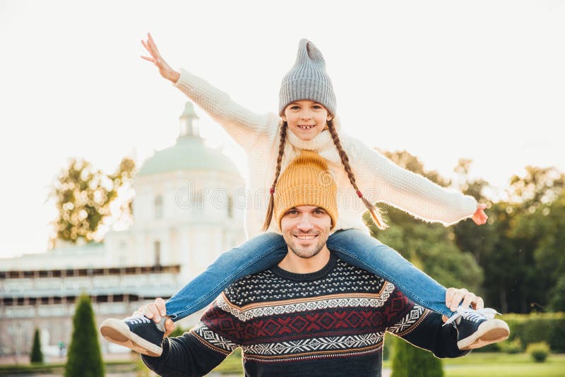 Horizontales Porträt des liebevollen Vaters gibt seiner Tochter Doppelpolfahrt draußen, Spiel zusammen, haben Spaß Glücklicher kl lizenzfreie stockfotos Horizontales Porträt des liebevollen Vaters gibt seiner Tochter Doppelpolfahrt draußen, Spiel zusammen, haben Spaß Glücklicher kl lizenzfreie stockfotos