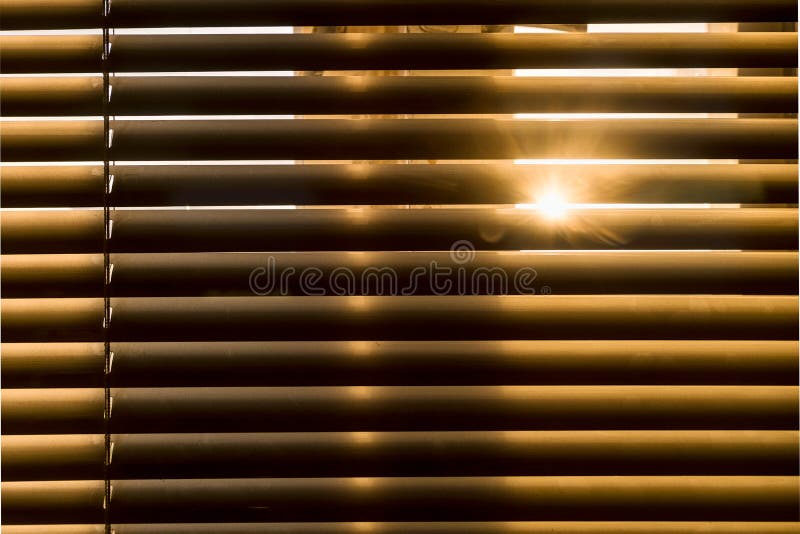 The sun passes through the blinds