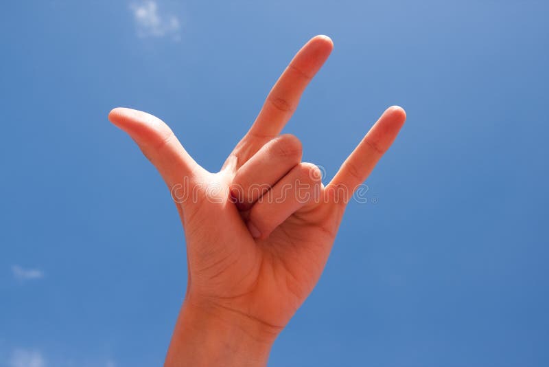 Horn Hand Sign Over Blue Sky Background Stock Photo Image of gesturing, communication 12375738