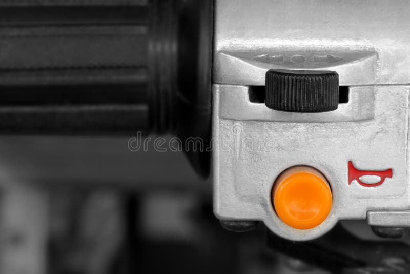 Horn switch on a motorcycle handlebar royalty free stock image