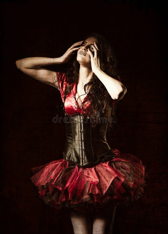 Horror shot: strange girl with mouth sewn shut among the dark. Grunge texture effect stock images Horror shot: strange girl with mouth sewn shut among the dark. Grunge texture effect stock images