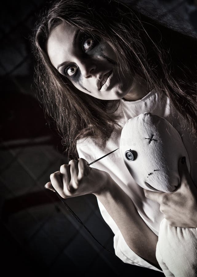 Horror Style Shot: Scary Mad Girl with Moppet Doll and Needle in Hands ...