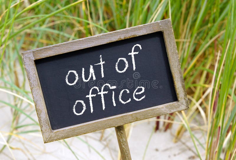 Chalk or blackboard sign with handwritten words Out of Office on sandy vacation beach. Chalk or blackboard sign with handwritten words Out of Office on sandy vacation beach.