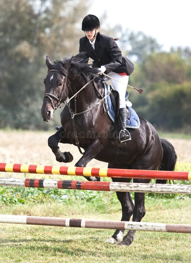 Show jumping.girl riding horse and jumping. Show jumping.girl riding horse and jumping