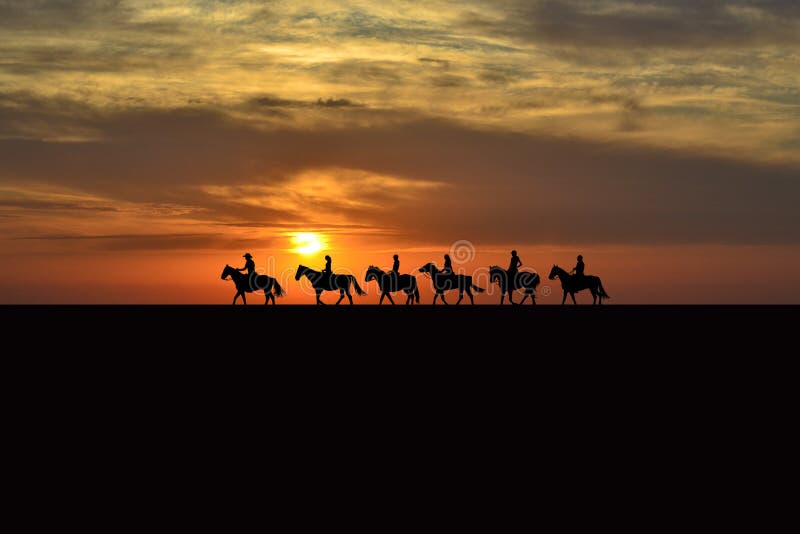 Horse rider silhouettes at sunset
