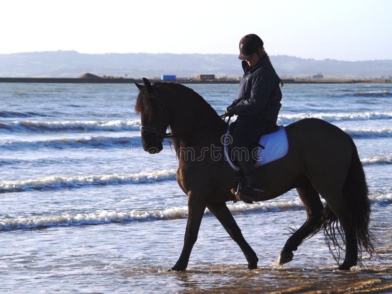 Horse Riding on the beach stock photo Horse Riding on the beach stock photo