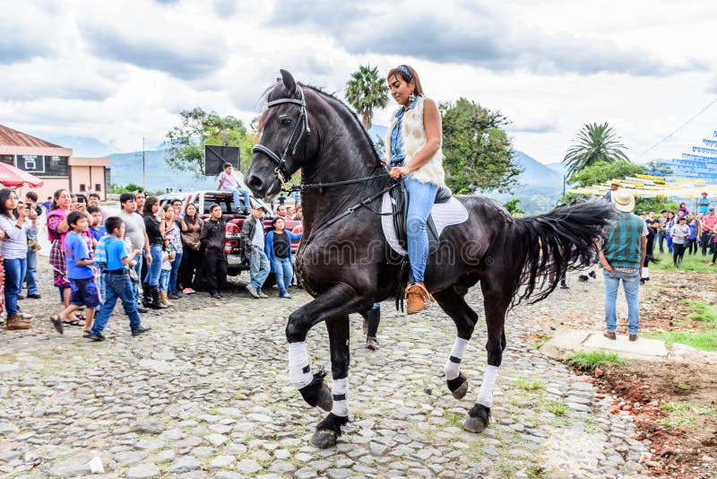 Horseback cowgirl rides in village, Guatemala royalty free stock photography Horseback cowgirl rides in village, Guatemala royalty free stock photography