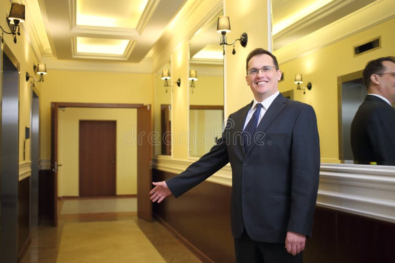 Hospitable Concierge in a Business Suit Standing Stock Image Image of indoors, enter 318316925