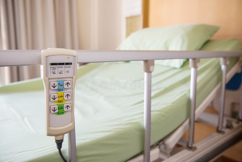 Hospital bed remote control hanging on the bed rail. technology of medical and hospital services. image for background, objects, copy space, illustration and article.