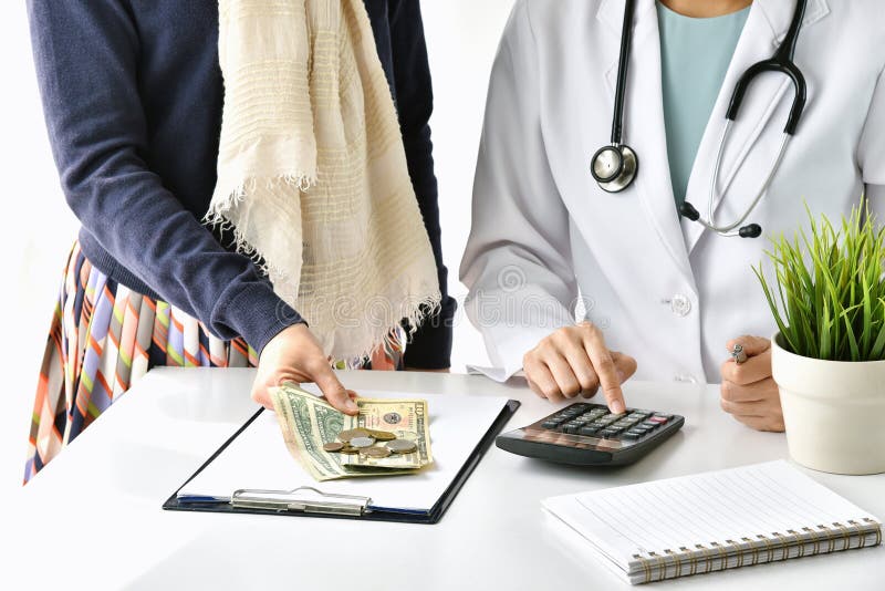 Hospital and medical expense, Doctor and woman patient calculate on disease treatment fee charges. stock photos Hospital and medical expense, Doctor and woman patient calculate on disease treatment fee charges. stock photos
