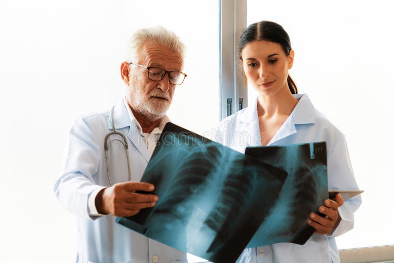 Two Doctors Examine Radiograph For Medical Xray Diagnosis In Sterile