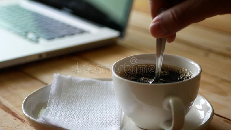 Stir the hot coffee in a cup with a spoo, Stock Video