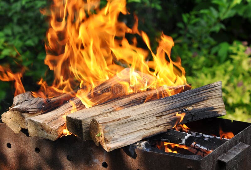 Hot Charcoal Barbecue Grill with Bright Flame on the Nature Stock Photo