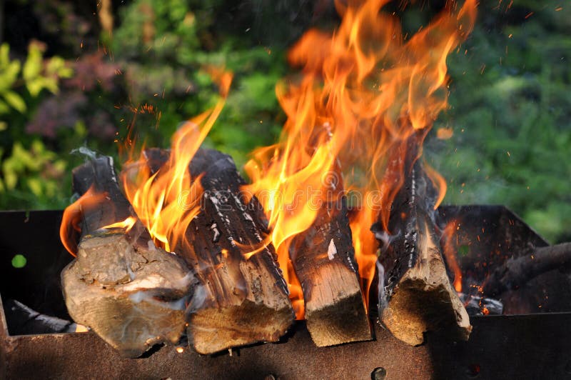 Hot Charcoal Barbecue Grill with Bright Flame on the Nature Stock Photo