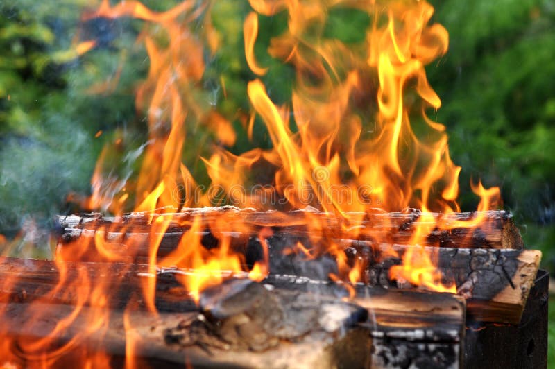 Hot Charcoal Barbecue Grill with Bright Flame on Nature Stock Photo