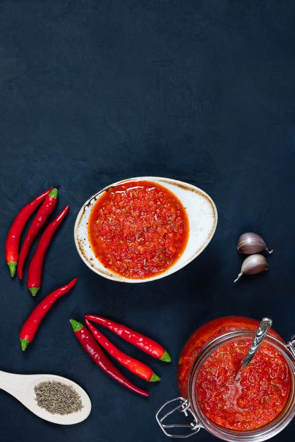 Hot Chili Pepper Sauce Paste Harissa. Adjika on a Blue Background ...