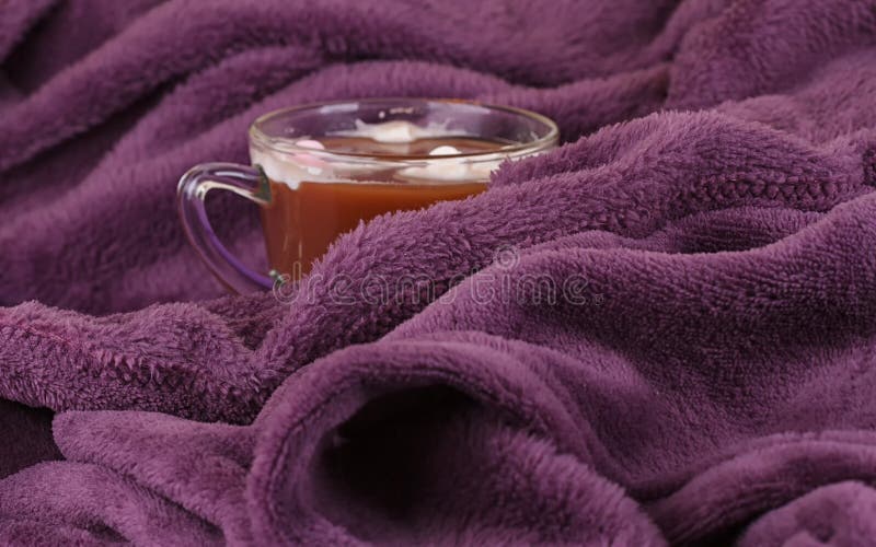Hot chocolate, cozy knitted blanket.