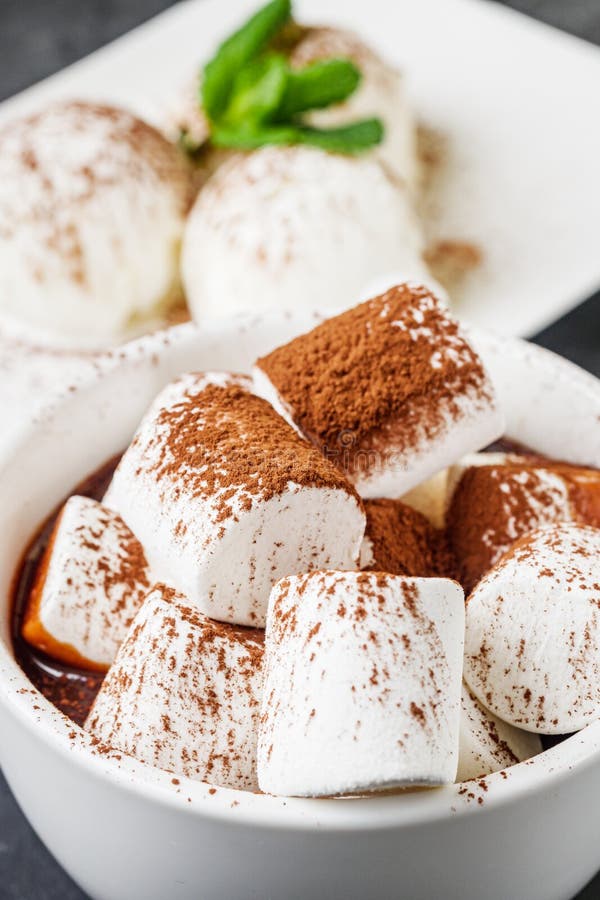 Hot Chocolate with Marshmallows and Ice Cream Balls on a Black