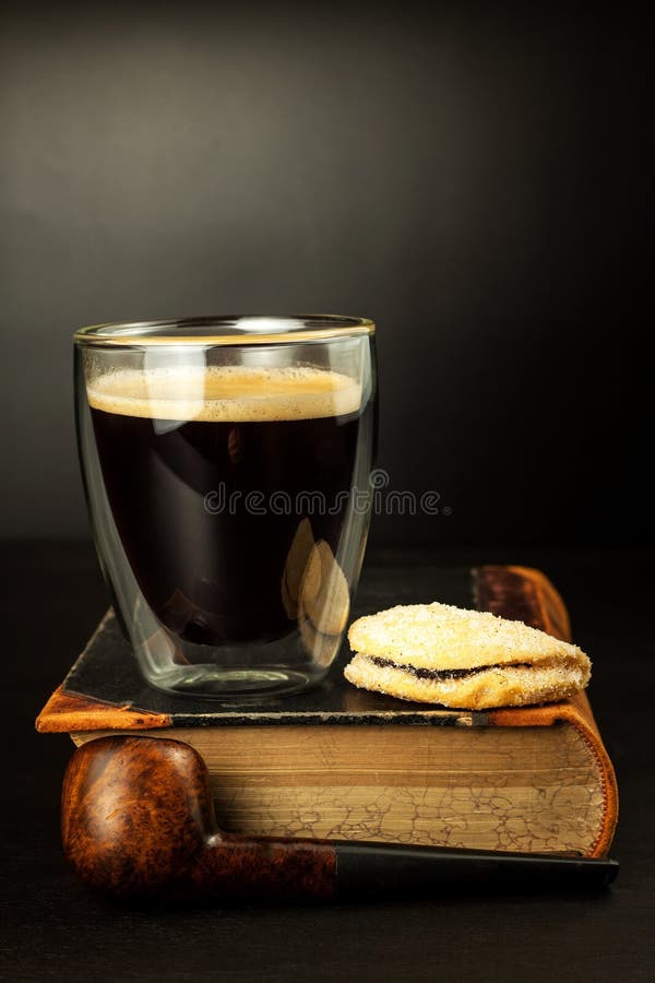 Hot Coffee and a Book on the Table. Old Smoking Pipe Stock Photo