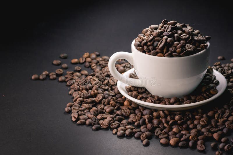 Coffee incup and coffee beans are the background. stock photography Coffee incup and coffee beans are the background. stock photography