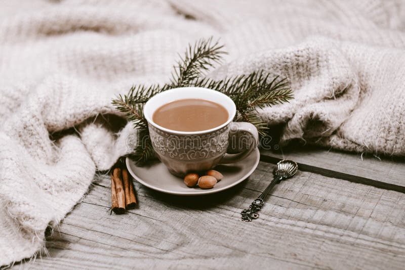 Hot Coffee Cup Wrapped Up in a Cozy Blanket with Decorations Stock