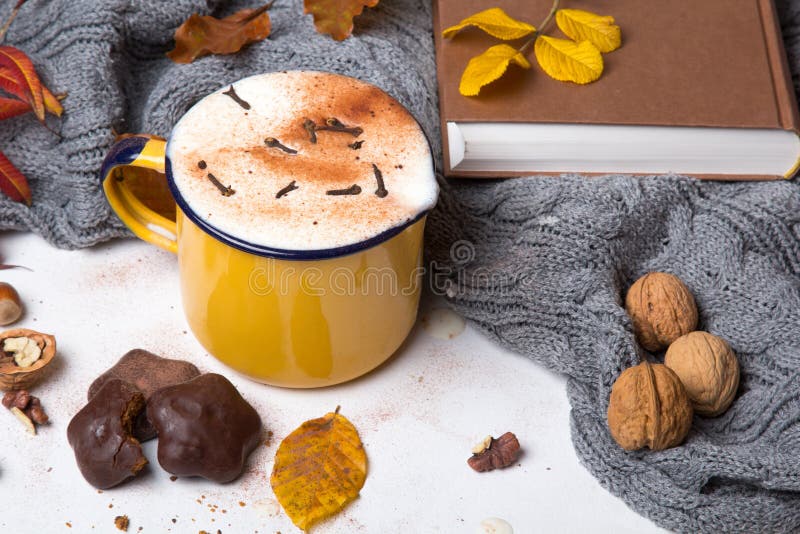 Hot coffee surrounded by autumn leaves. royalty free stock photo