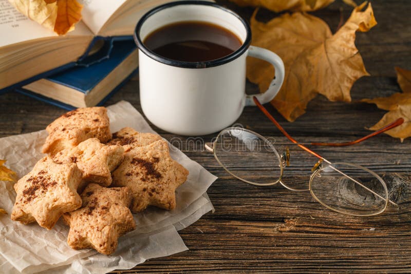 Hot coffee, vintage book, glasses and autumn leaves on wood back stock photos Hot coffee, vintage book, glasses and autumn leaves on wood back stock photos