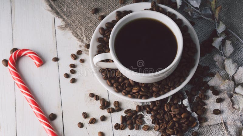 A Hot Cup Of Coffee With A Candy And The Coffee Beans On The Table In A Cafe Composition Of A Delicious Coffee And Stock Image Image Of Cloth Candy 180346737