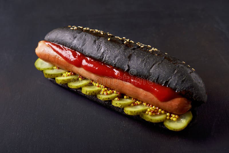 Hot dog in black bun stock image. Image of sausage, bread 95217901