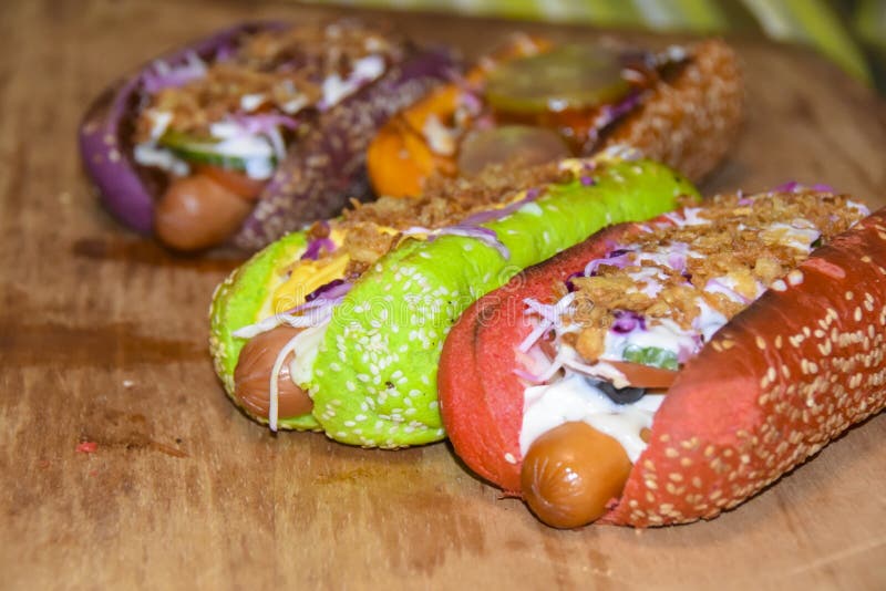 Hot Dogs Assorted Multicolored Buns Different Toppings on Green Plate