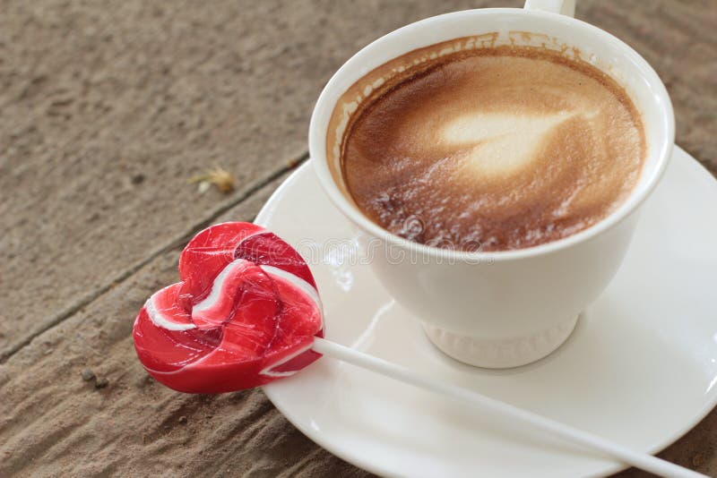 Hot latte coffee in glass and candy sweet valentines heart