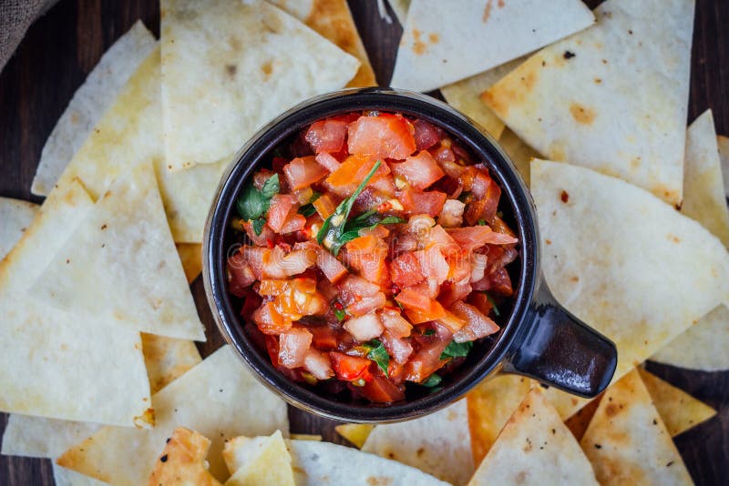 Hot mexican salsa - spicy dip with nachos - chips from corn stock photo Hot mexican salsa - spicy dip with nachos - chips from corn stock photo