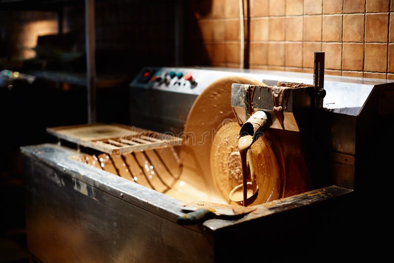 Hot milk chocolate flow or stream on factory stock photo Hot milk chocolate flow or stream on factory stock photo