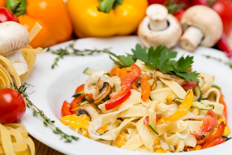 Hot pasta with garnish on plate stock photography