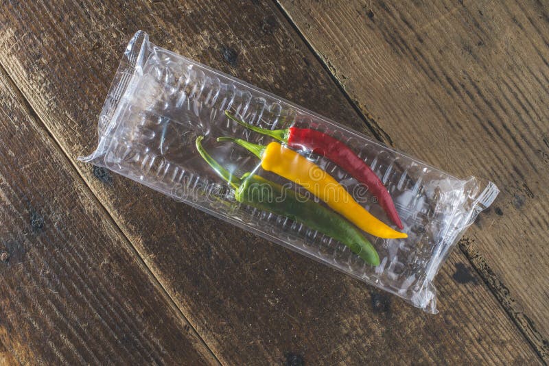 Hot peppers on wooden cutting board stock images