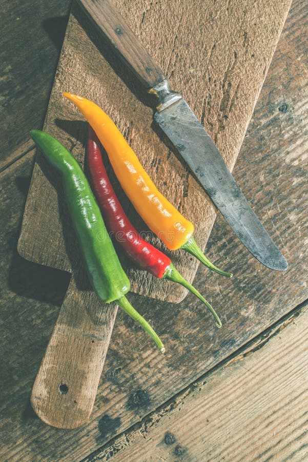 Hot peppers on wooden cutting board royalty free stock photography