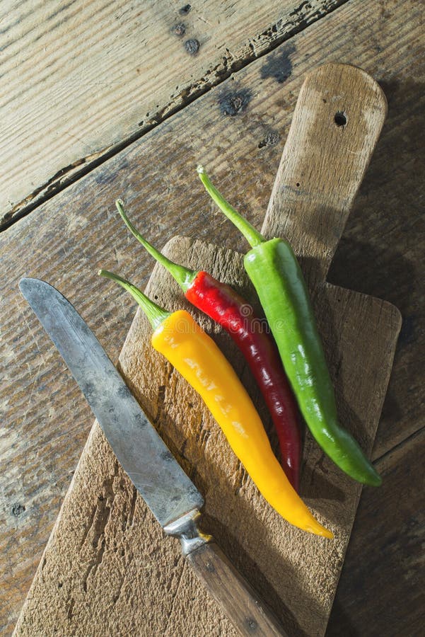 Hot peppers on wooden cutting board royalty free stock image